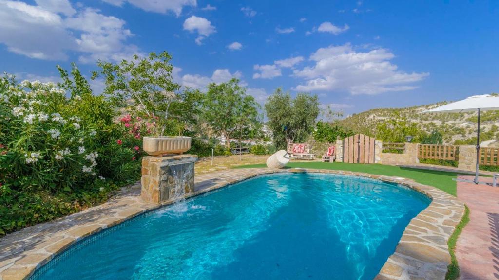 a swimming pool in a yard with a patio at Cortijo la Era Castril by Ruralidays in Castril