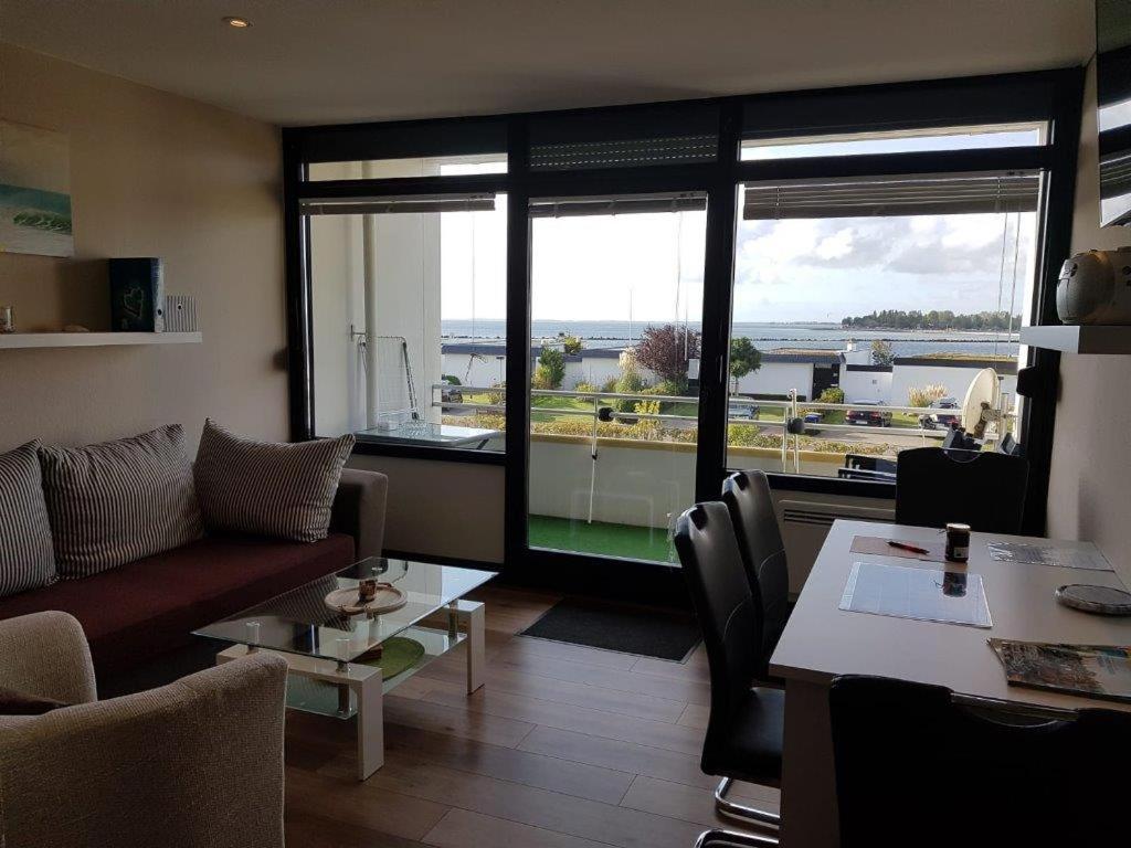 a living room with a couch and a table at Appartement mit Balkon und Meerblick in Fehmarn