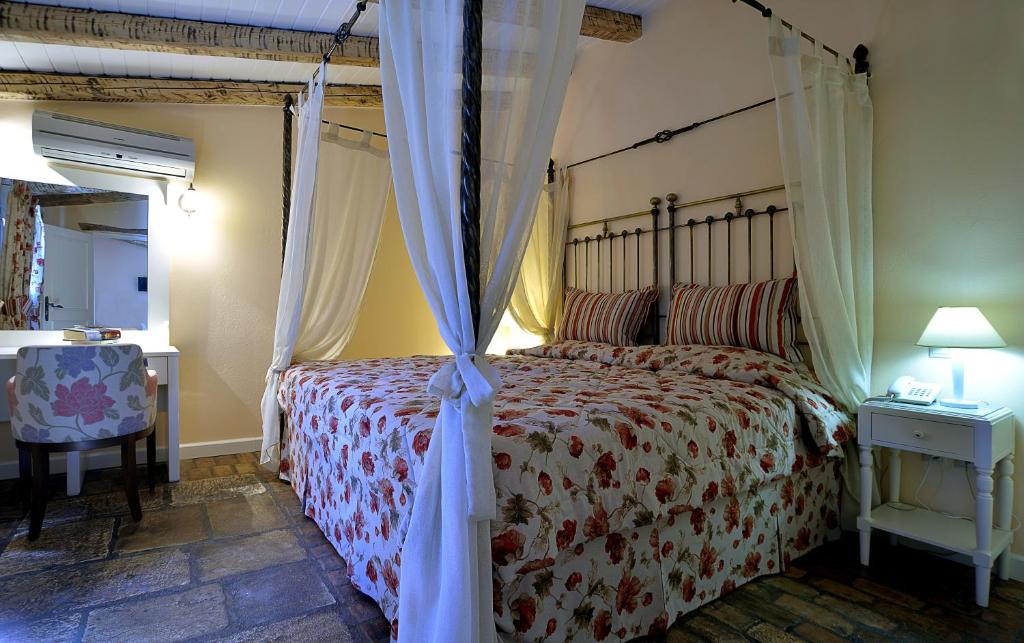 a bedroom with a bed with a canopy at Fundana Villas in Liapades