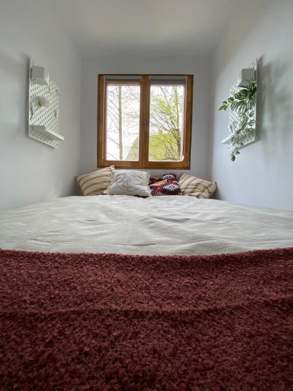 uma cama grande num quarto com uma janela em 99Heaven Vendégház/ Panorámás faházikó Nagymaroson em Nagymaros