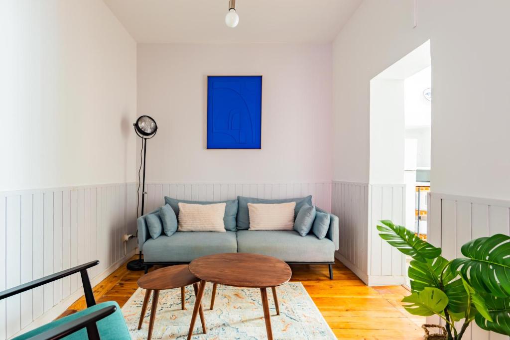 a living room with a couch and a table at Casa de Santana in Lisbon