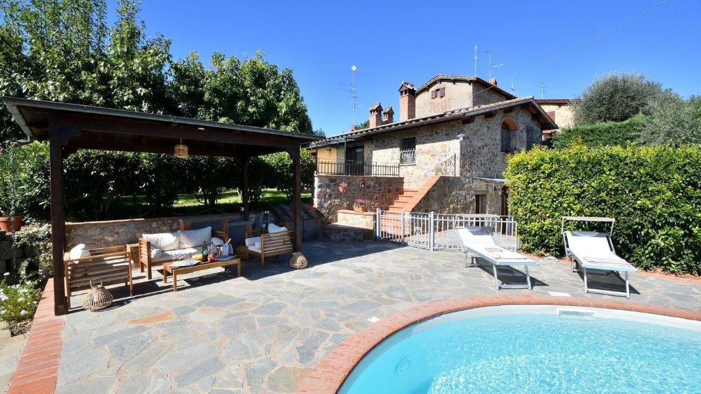 a backyard with a swimming pool and a house at Podere La Casa in Cavriglia