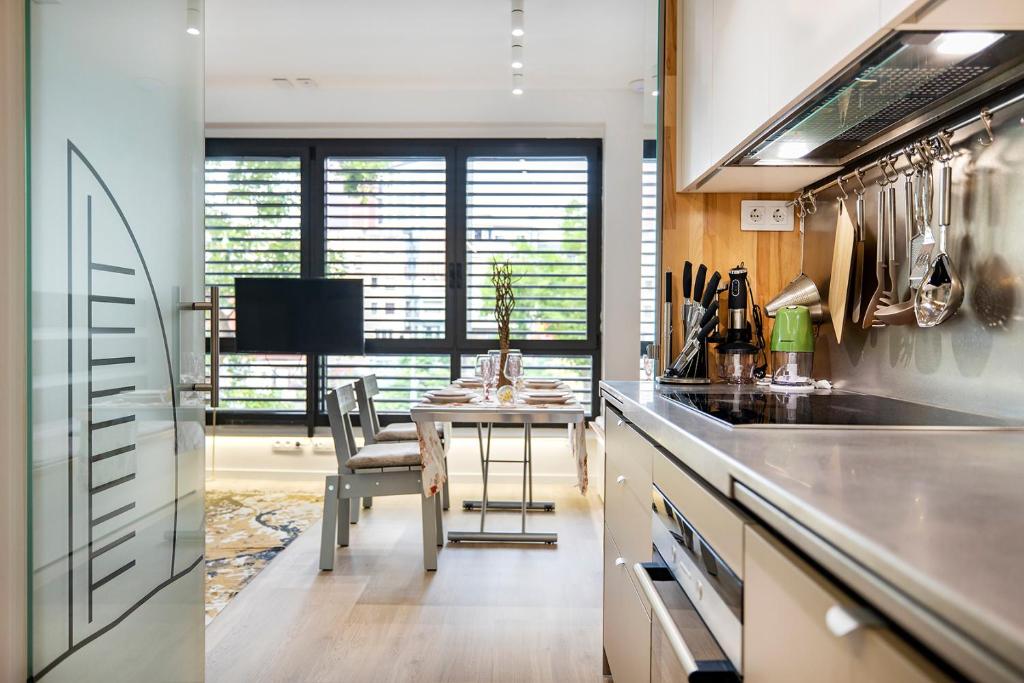 a kitchen with a table and a dining room at At-II Hub Luxury New Apartments in Barcelona