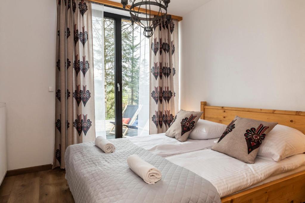 Posteľ alebo postele v izbe v ubytovaní udanypobyt Apartamenty Krzeptówki Potok