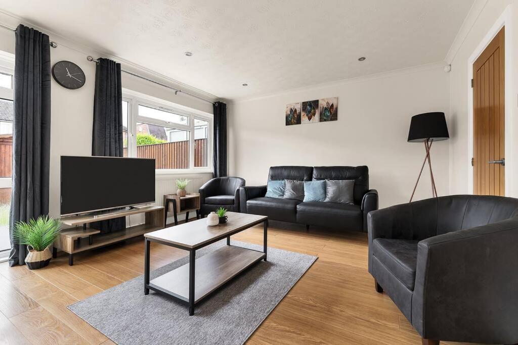 a living room with a couch and a tv at Charming 3BR house with garden in Cambridge - Cherry Hinton in Cherry Hinton