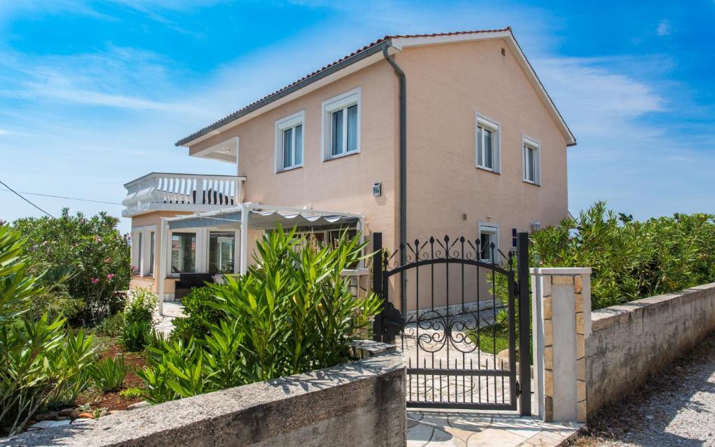 a house with a gate in front of it at Holiday home Nika in Linardići