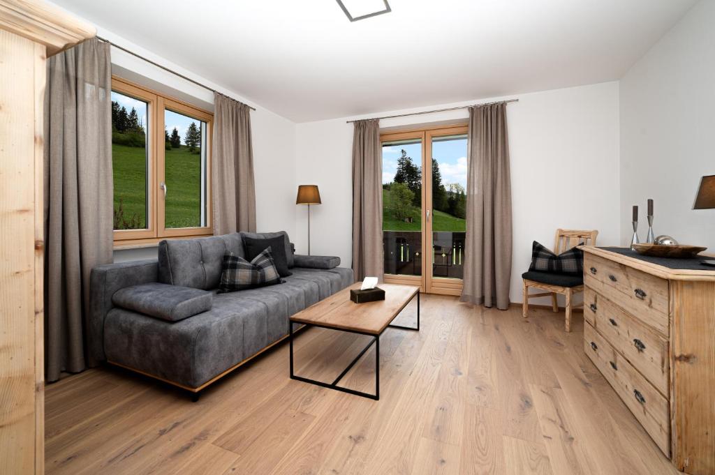 a living room with a couch and a table at Ferienappartements Schrattengut in Abtenau