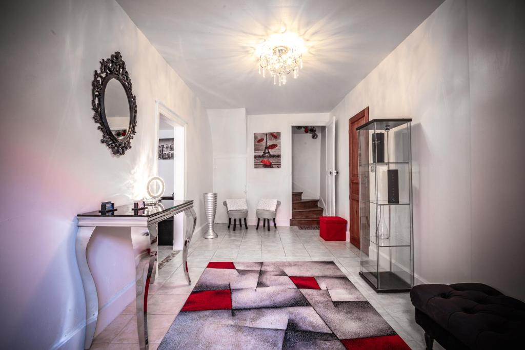 a living room with a table and a refrigerator at Gîte Chez Louis le Tonnelier Suite First in Le Mesnil-sur-Oger