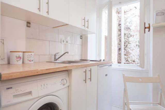 a white kitchen with a sink and a washing machine at Vintage Apartment Rovinj Old Town in Rovinj