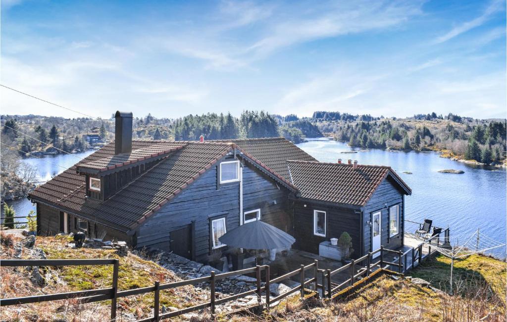 a house on the edge of a body of water at Beautiful Home In Frresfjorden With 4 Bedrooms, Sauna And Wifi in Sørvåg