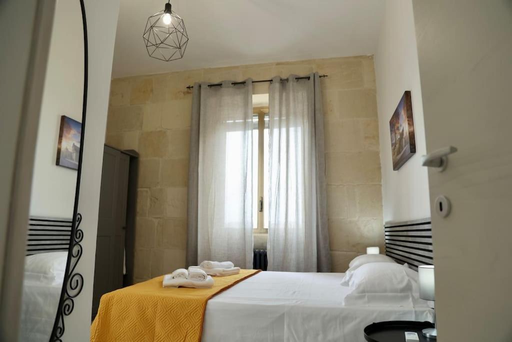 a bedroom with a large bed and a mirror at [Otranto in 10 min]-Free Parking in Maglie