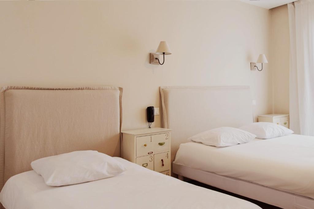 Postel nebo postele na pokoji v ubytování Coq Hotel