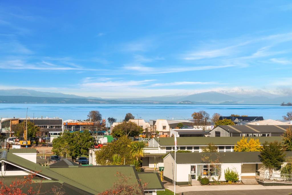 a cityscape of a town with the ocean in the background at Lakeview Luxury - Taupo Holiday Apartment in Taupo