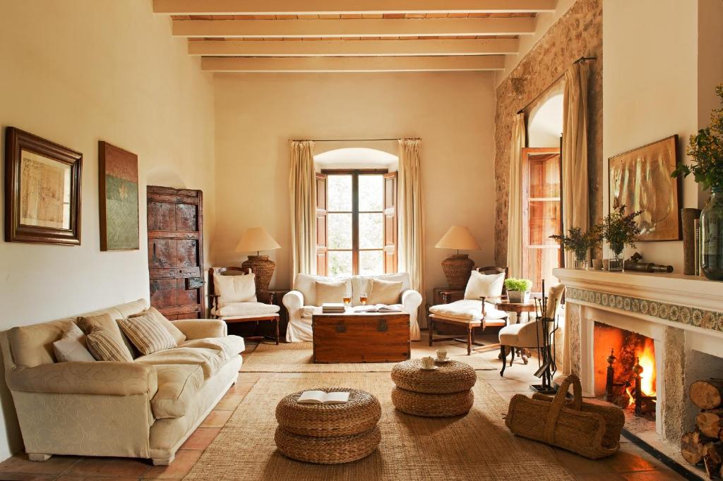 a living room with a couch and a fireplace at Mirabó de Valldemossa in Valldemossa