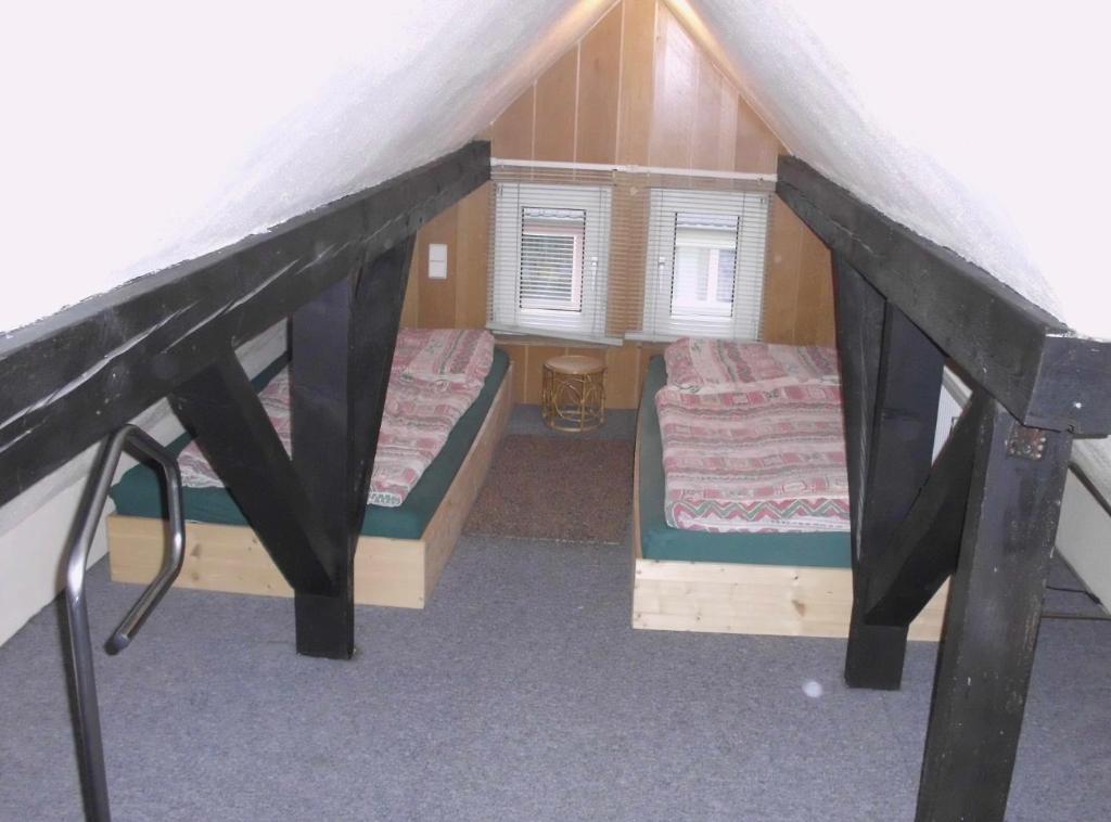 a small room with two beds in a attic at Gemütliche Wohnung 2 Et Inkl Parkplatz nach Verfügbarkeit in Essen