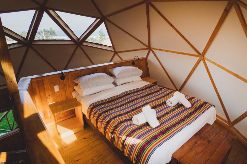 Tempat tidur dalam kamar di Pichilemu Domos