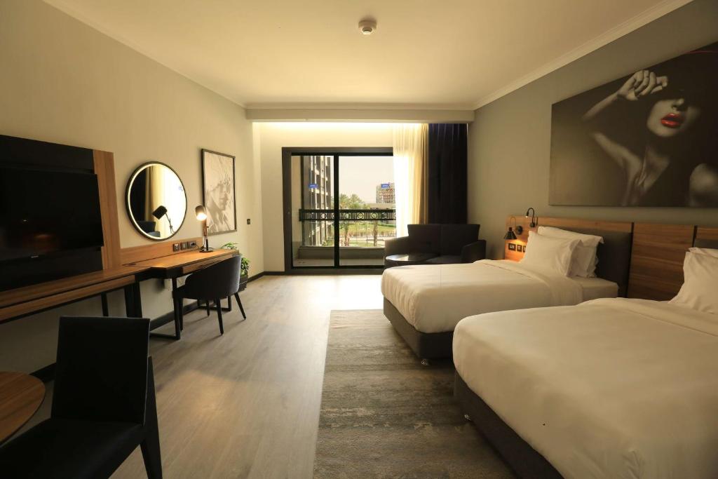 A bed or beds in a room at Radisson Blu Hotel & Convention Center, Alexandria