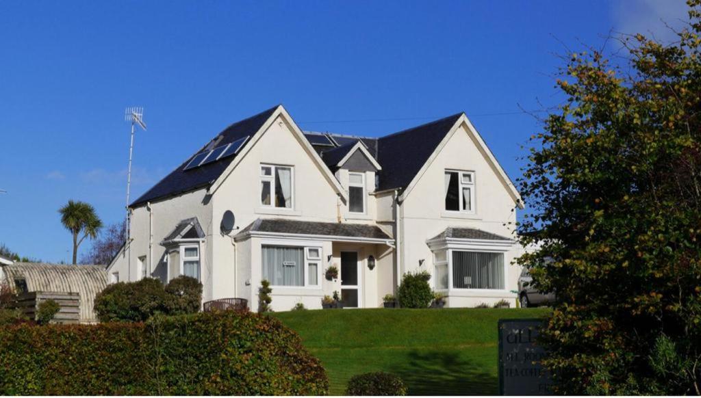 a large white house with a black roof at Allandale House in Brodick