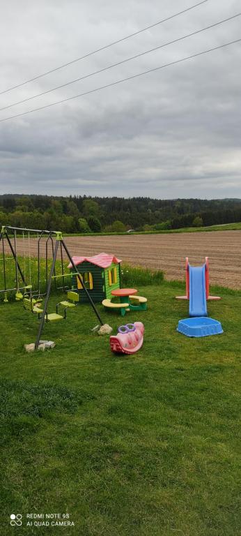 a group of playground equipment in a grass field at Durchreisestop mit Kinder am außergewöhnlichen Spitzboden mit Autobetten und Bad ,Küche im Souterain in Deining
