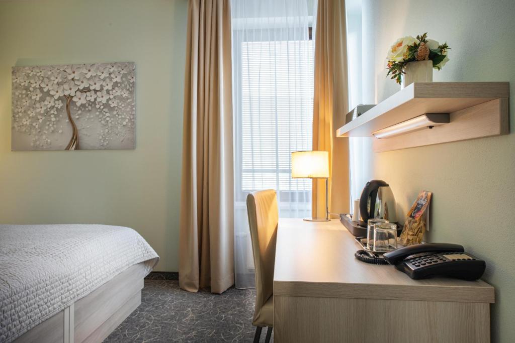 Postel nebo postele na pokoji v ubytování Hotel Mlynska