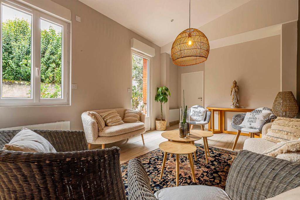 a living room with couches and a table at Pleasant and bright chartreuse with terrace in Toulouse