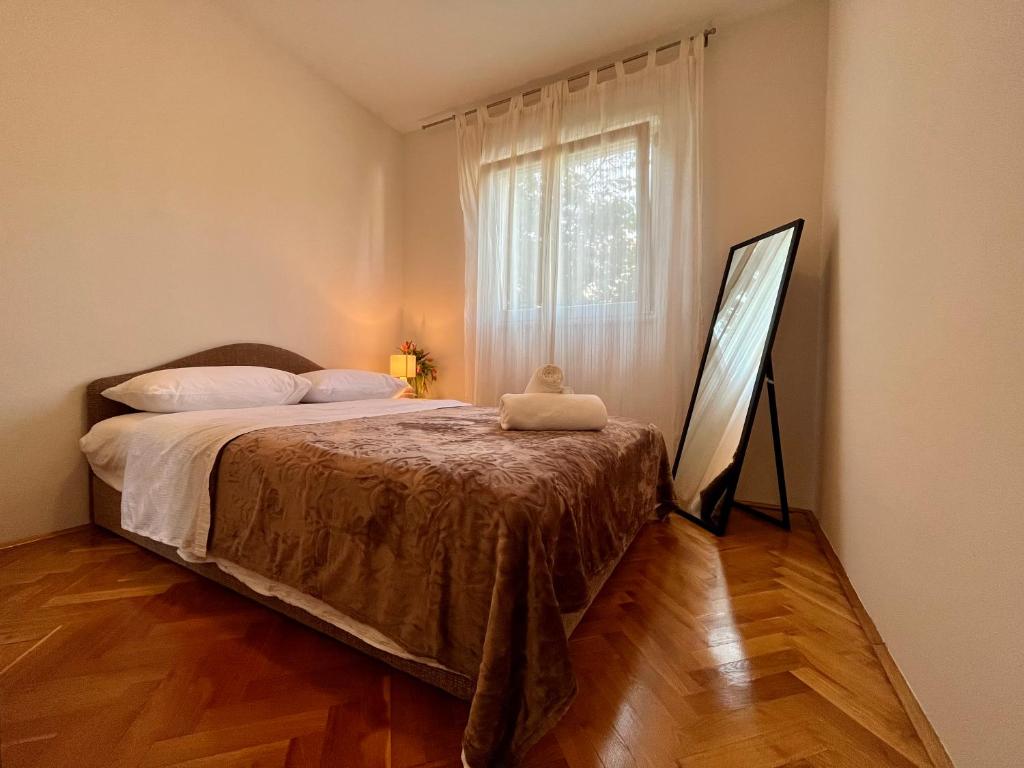 a bedroom with a bed and a large window at City Place in Split