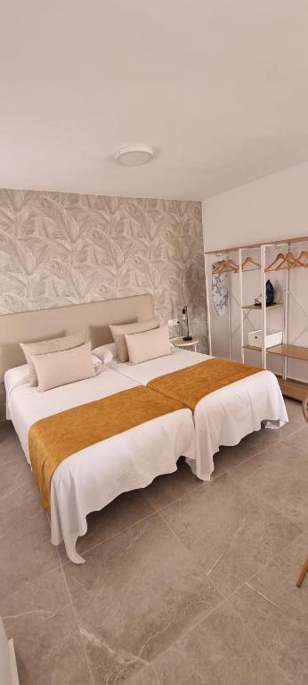 a large bedroom with two beds in it at ESTUDIO LA ESTRELLA in Candelaria