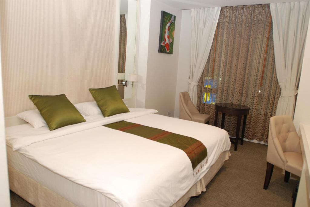Postel nebo postele na pokoji v ubytování Aphrodite Inn Bangkok