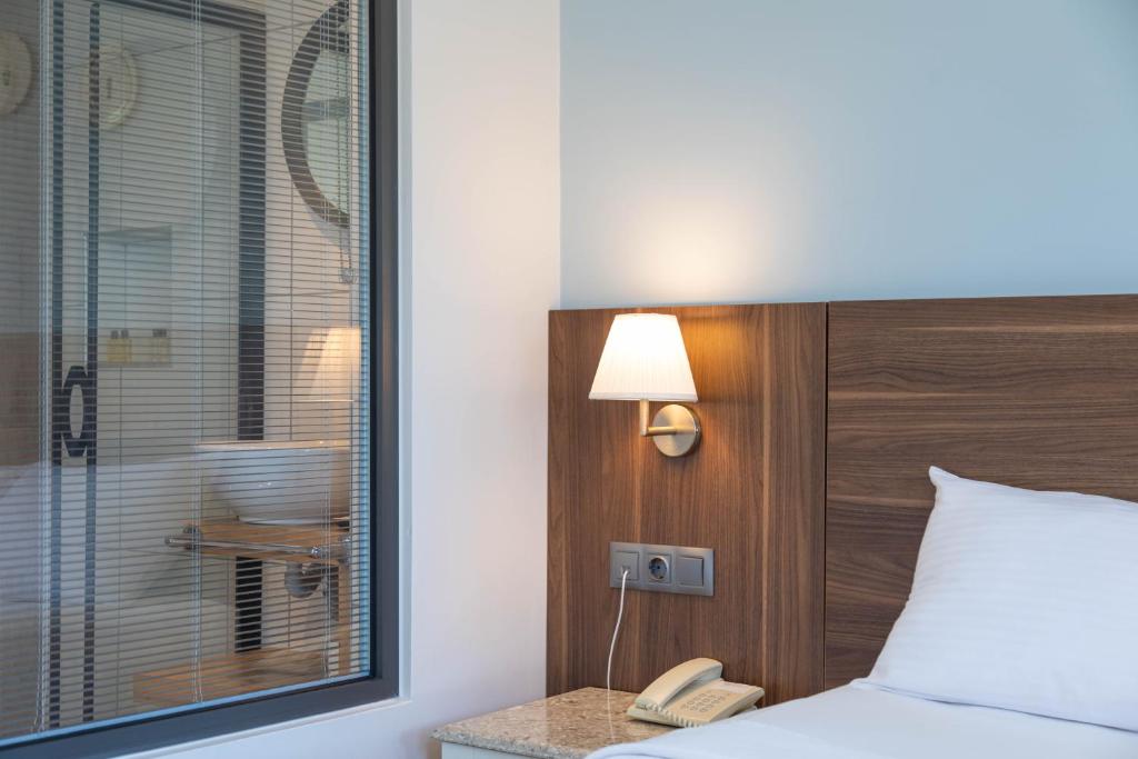 Postel nebo postele na pokoji v ubytování Bronze Hotel