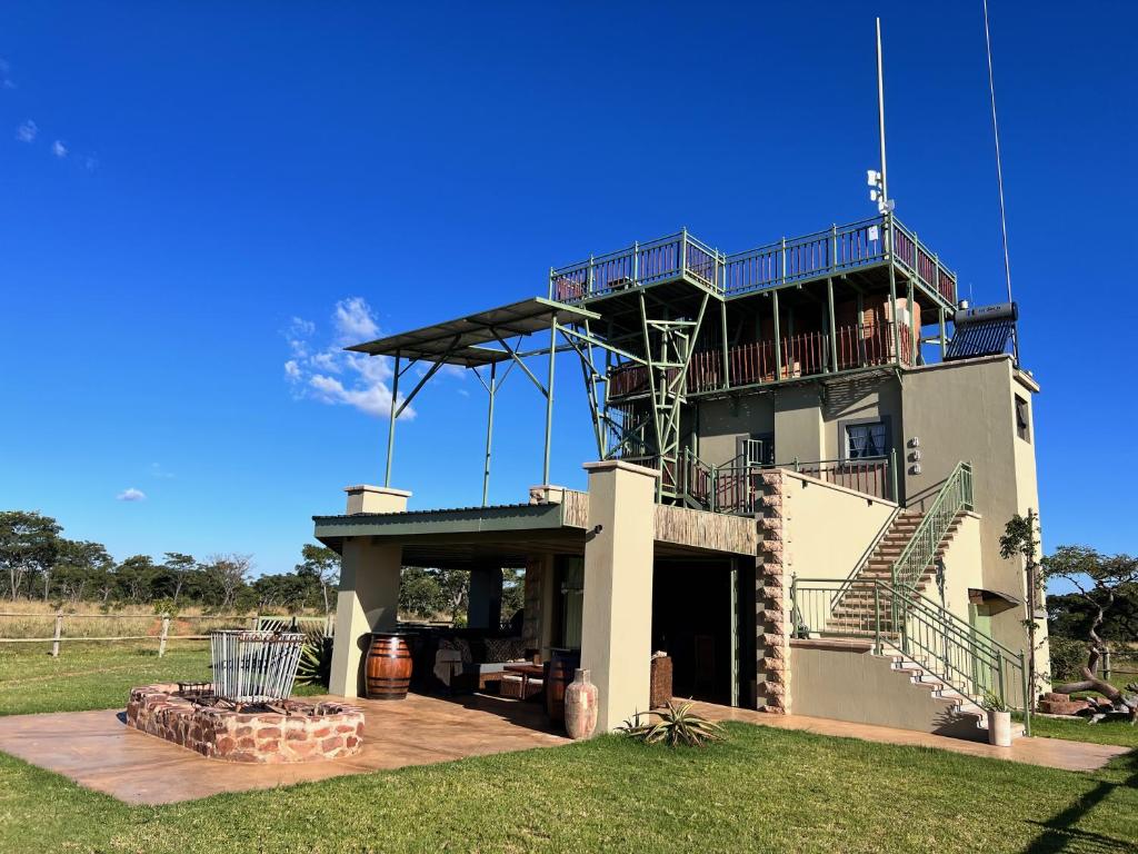 a house with a balcony and stairs on it at Rockey Mountain Tower in Bela-Bela
