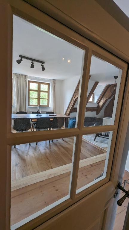 a view of a living room through a glass door at LIBORIA III Wohnen im Denkmal Augsburgs in Augsburg