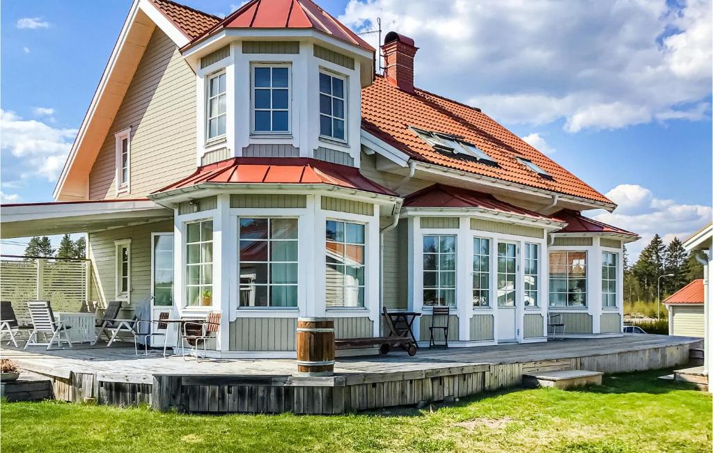 a house with a porch with a bench on a patio at Beautiful Home In Gvle With Sauna in Gävle