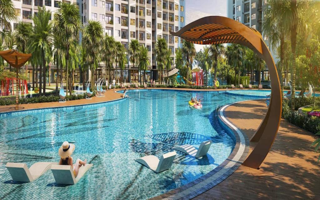 a large swimming pool in a city with palm trees at Lu Luxury Homestay et Apartment - Vinhomes Smart City Hanoi in Hanoi
