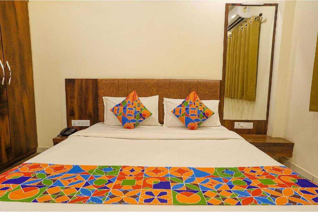 a bedroom with a large bed with a colorful comforter at OYO 92093 Mahaveer Tower in Udaipur