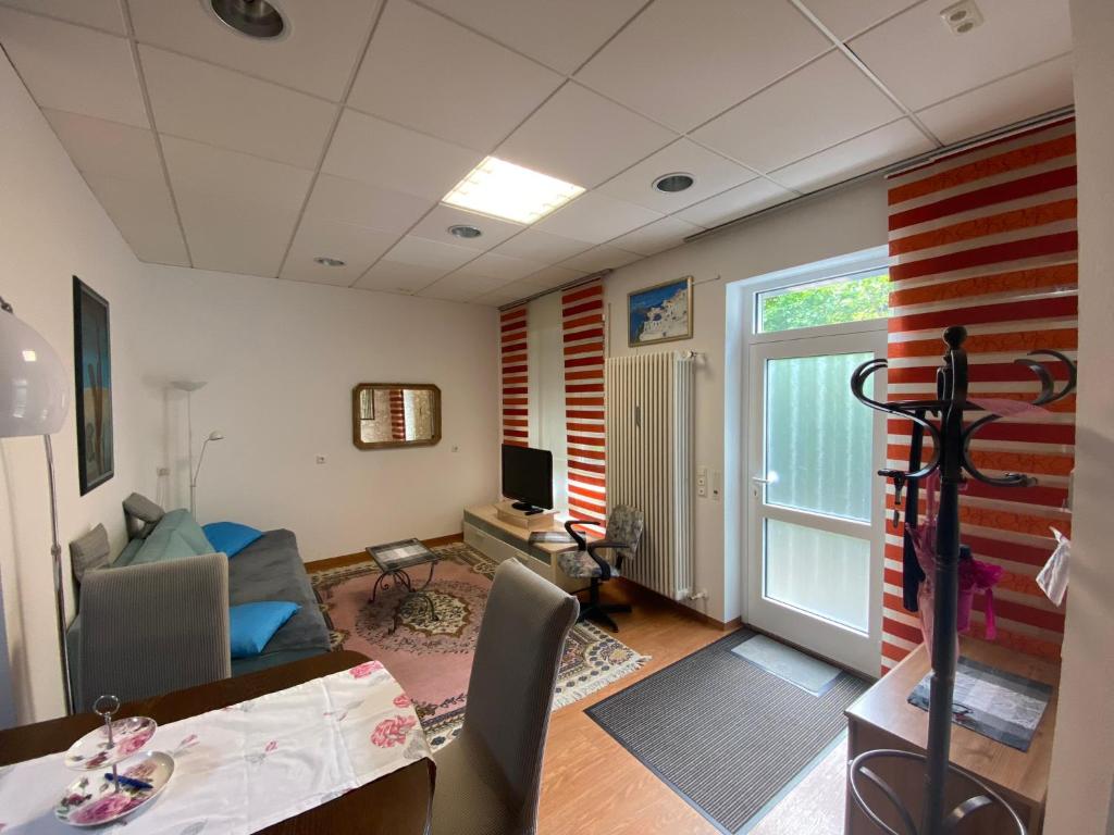 a living room with a couch a table and a television at Ferienwohnung Aktuell in Memmingen