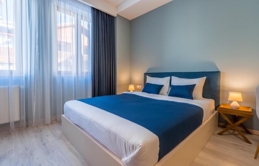 Postel nebo postele na pokoji v ubytování New Gudauri GoodHost Apartments
