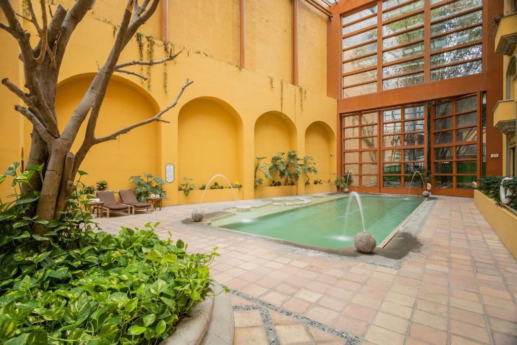 an indoor swimming pool in a building at Quinta Real Monterrey in Monterrey