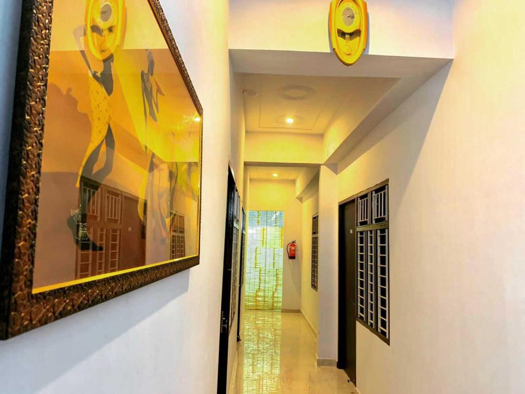 a hallway with paintings on the walls of a house at OYO Four Seasons Hotel in Meerut