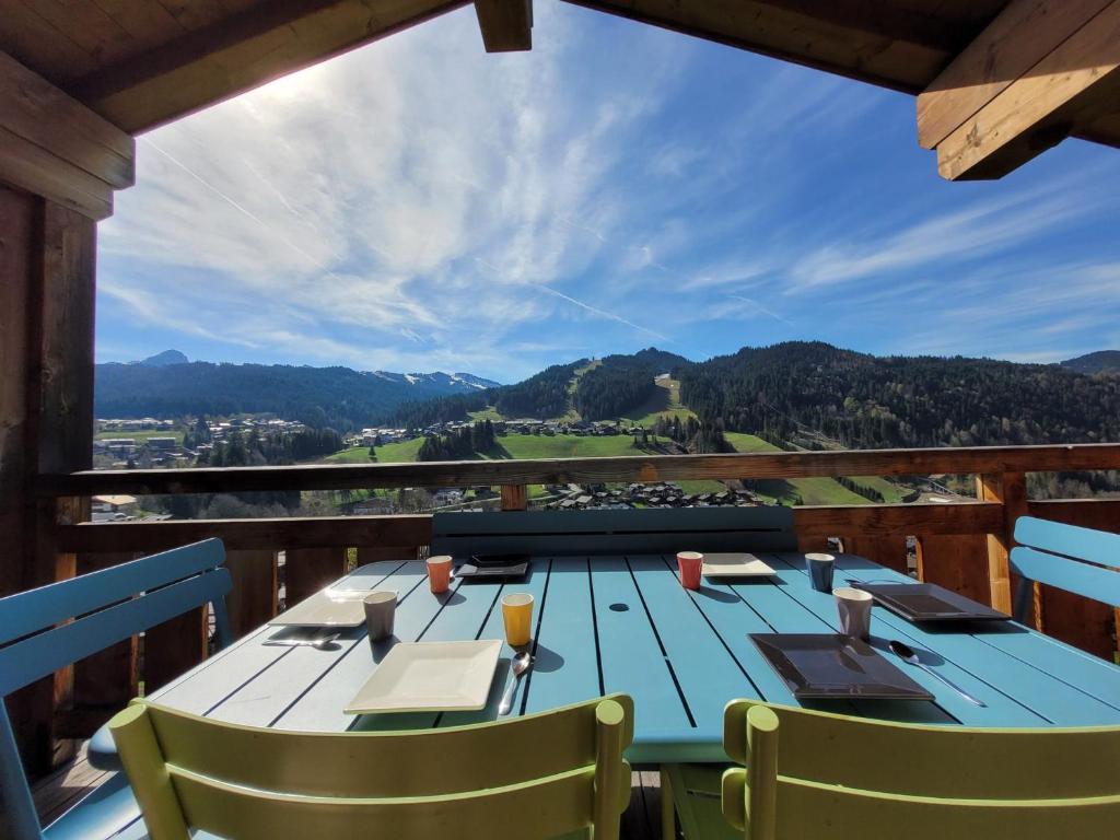 a blue table on a balcony with a view at Chalet Les Gets, 5 pièces, 6 personnes - FR-1-598-24 in Les Gets