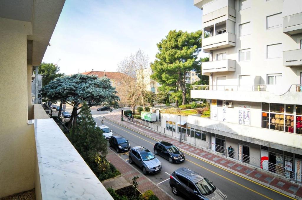 a view of a city street with cars parked at Apartmani Andjelka in Tivat