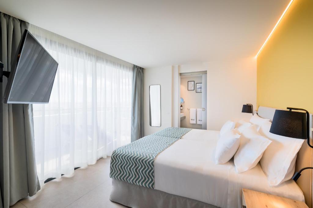 A bed or beds in a room at Barceló Margaritas Royal Level Adults Only