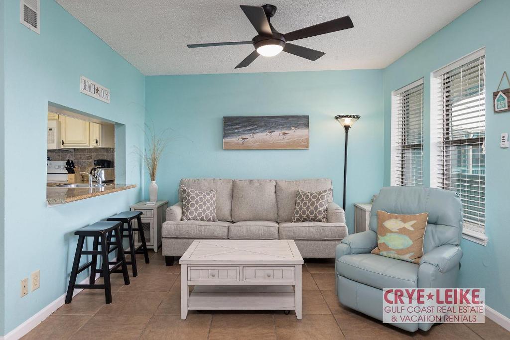 a living room with a couch and a table at Sea Breeze 305 in Gulf Shores