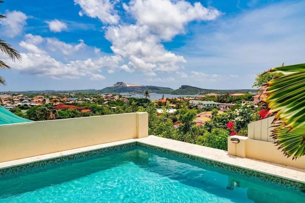 a swimming pool in a villa with a view at Million dollar view Spanish Hacienda Style Luxury Villa in Jan Thiel in Jan Thiel