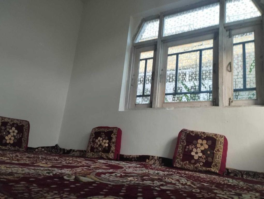 a room with two beds and two windows at POP Masrat Homestay 