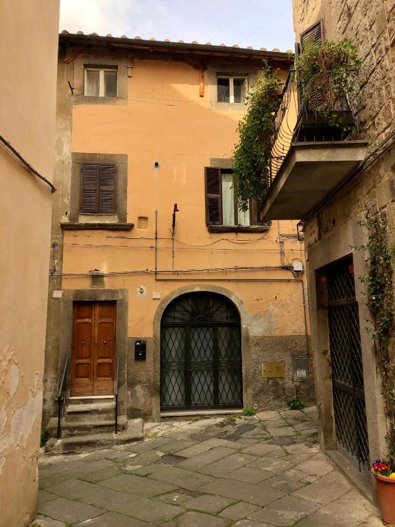 an old building with two doors and a balcony at VITERBO ART APARTMENTS in Viterbo
