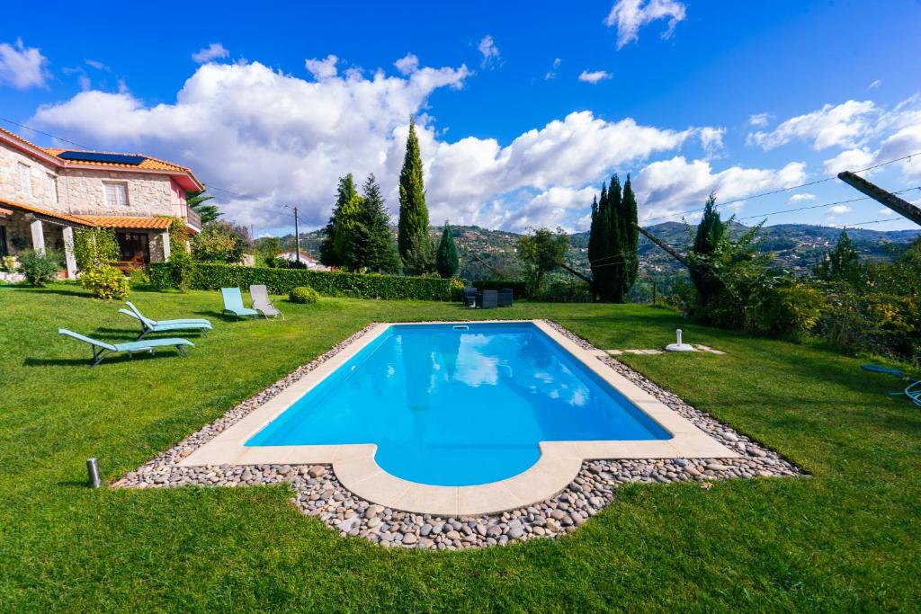 a swimming pool in the yard of a house at Leiras de Candoz Douro Valley in Marco de Canaveses