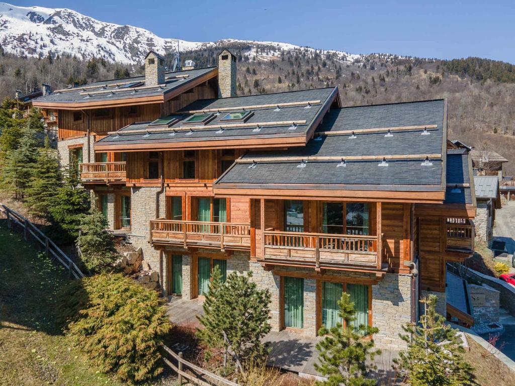 a large house with solar panels on its roof at Chalet Méribel, 7 pièces, 12 personnes - FR-1-566-44 in Les Allues