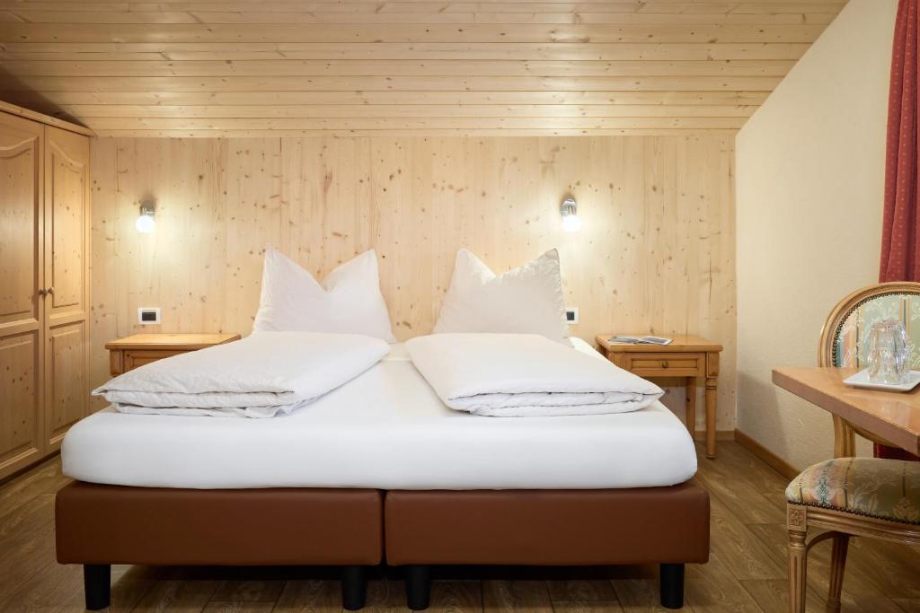 a bedroom with two white pillows on a bed at Hotel B&B Frohsinn in Badia