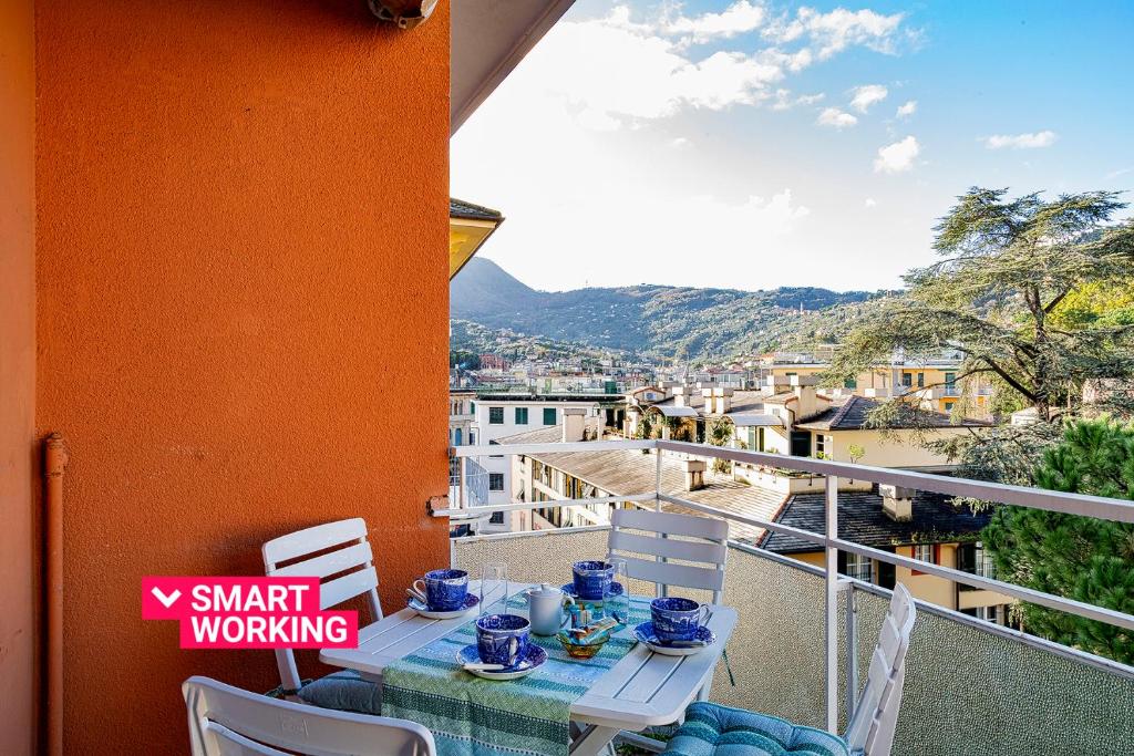 a table and chairs on a balcony with a view at Casa Rita in Riviera in Santa Margherita Ligure