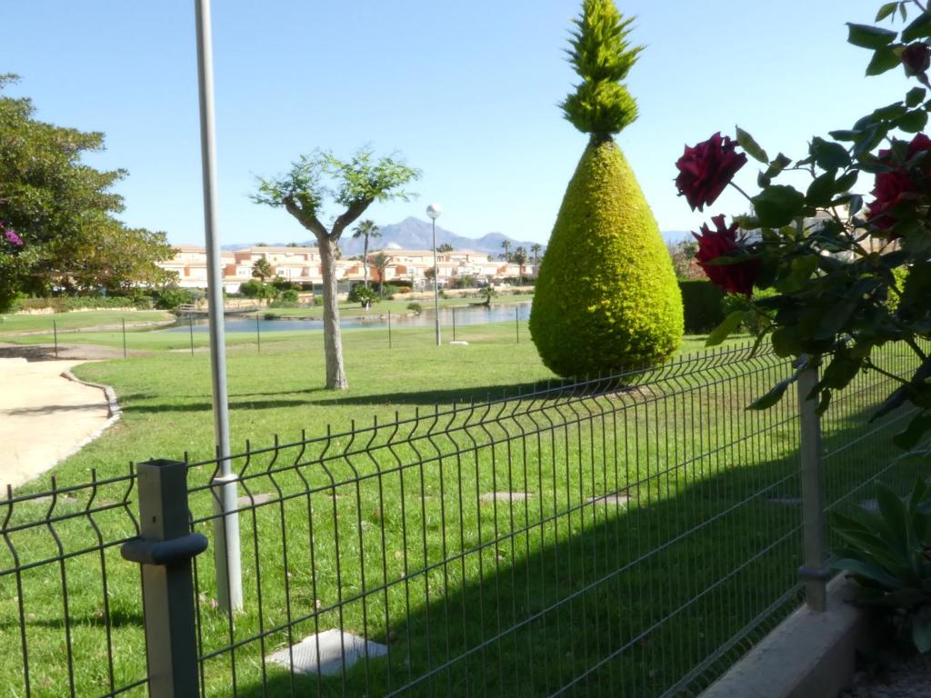 een hek met een struik in een park bij GOLF Y PLAYA EN SAN JUAN in Alicante